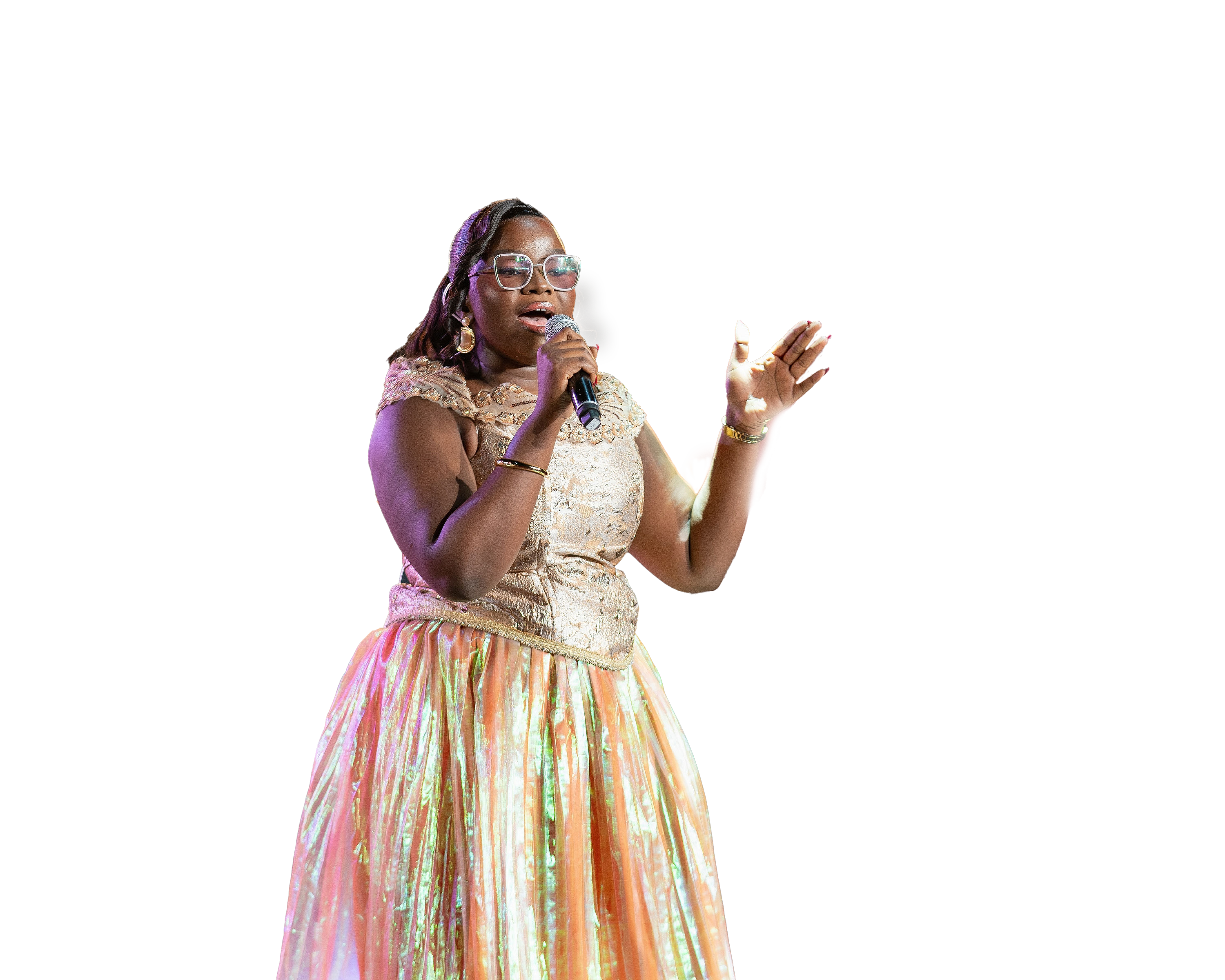 Purity Atieno on stage with arms raised under golden concert lights
